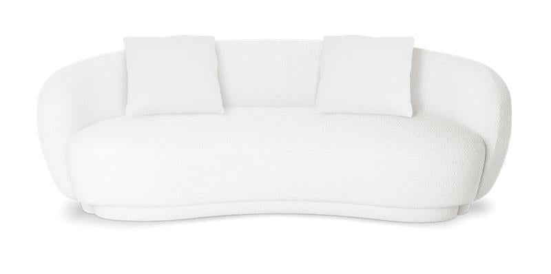 White bouclé curved sofa with two matching throw cushions against a plain white studio background.