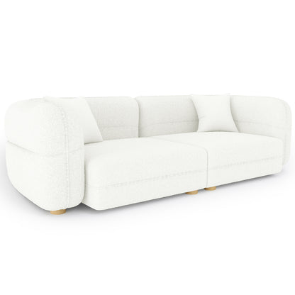 Kaelyn 3 Seater Modular Boucle Sofa with Pillows in Cream, featuring a low-profile design, white bouclé upholstery, gently rounded armrests, short wooden legs, and two matching throw pillows.