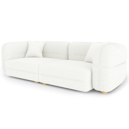 Kaelyn 3 Seater Modular Boucle Sofa with Pillows in Cream features a modern, low-profile design with two modular sections, white bouclé upholstery, rounded arms, wooden legs, and matching throw pillows.