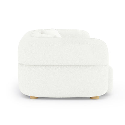 Kaelyn 3 Seater Modular Boucle Sofa with Pillows in Cream features a low-profile, rounded design with white boucle upholstery, thick cushioned back and seat, and short cylindrical wooden legs.
