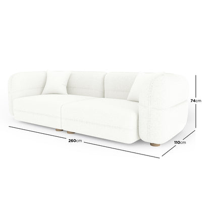 Kaelyn 3 Seater Modular Boucle Sofa with Pillows in Cream, featuring a modern, low-profile design with softly rounded edges and two matching throw pillows, measuring 260cm wide by 110cm deep.