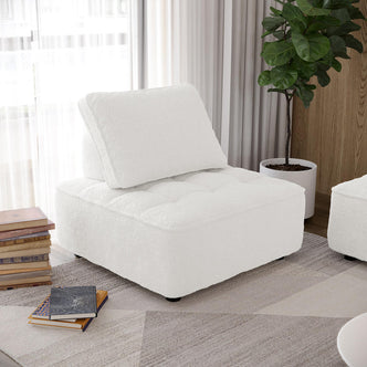 Kazumi Boucle Modular Single Sofa Chair in Cream White, centered in a modern living area, features boucle fabric and sleek design. Positioned beside books and a fiddle-leaf fig, enhancing minimalist decor.