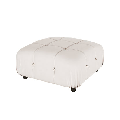 Keila 3 Seater Modular Tufted Sofa with Ottoman in Cream features a low, square ottoman with light-cream fabric, tufted sections with metal rings, and short black feet, showcasing modern elegance.