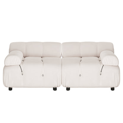 Keila 2 Seater Sofa & Side Table Package in Cream Velvet features a low-profile, two-seat sofa with deep, tufted cushions, wide rolled armrests, and decorative metal rings, paired with a mother-of-pearl inlay side table.