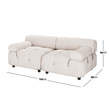 Keila 2 Seater Sofa & Side Table Package in Cream Velvet features a low-slung, tufted design with rolled armrests, decorative ties, and small black feet, plus an interchangeable ottoman chaise.