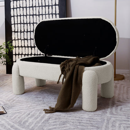 Lonea Bouclé Upholstered Bench w/ Storage Light Beige, featuring soft boucle fabric, cushioned seating, and a discreet storage compartment, positioned indoors with a blanket draped over it.