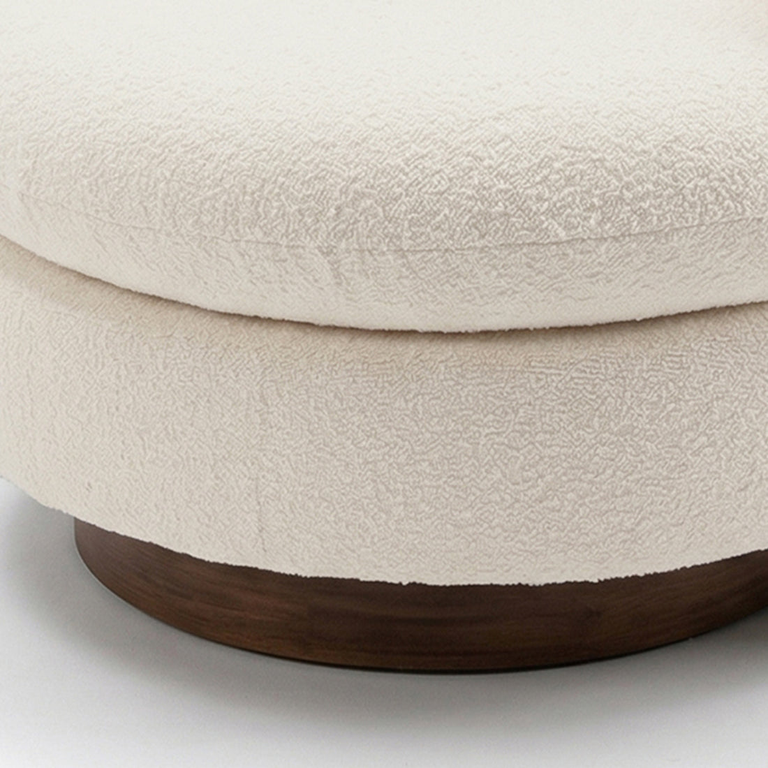 Close-up of the Marvik 360° Swivel Accent Chair in Cream White, showcasing its textured boucle upholstery on a round cushion, atop a dark wood base, emphasizing its modern, elegant design.