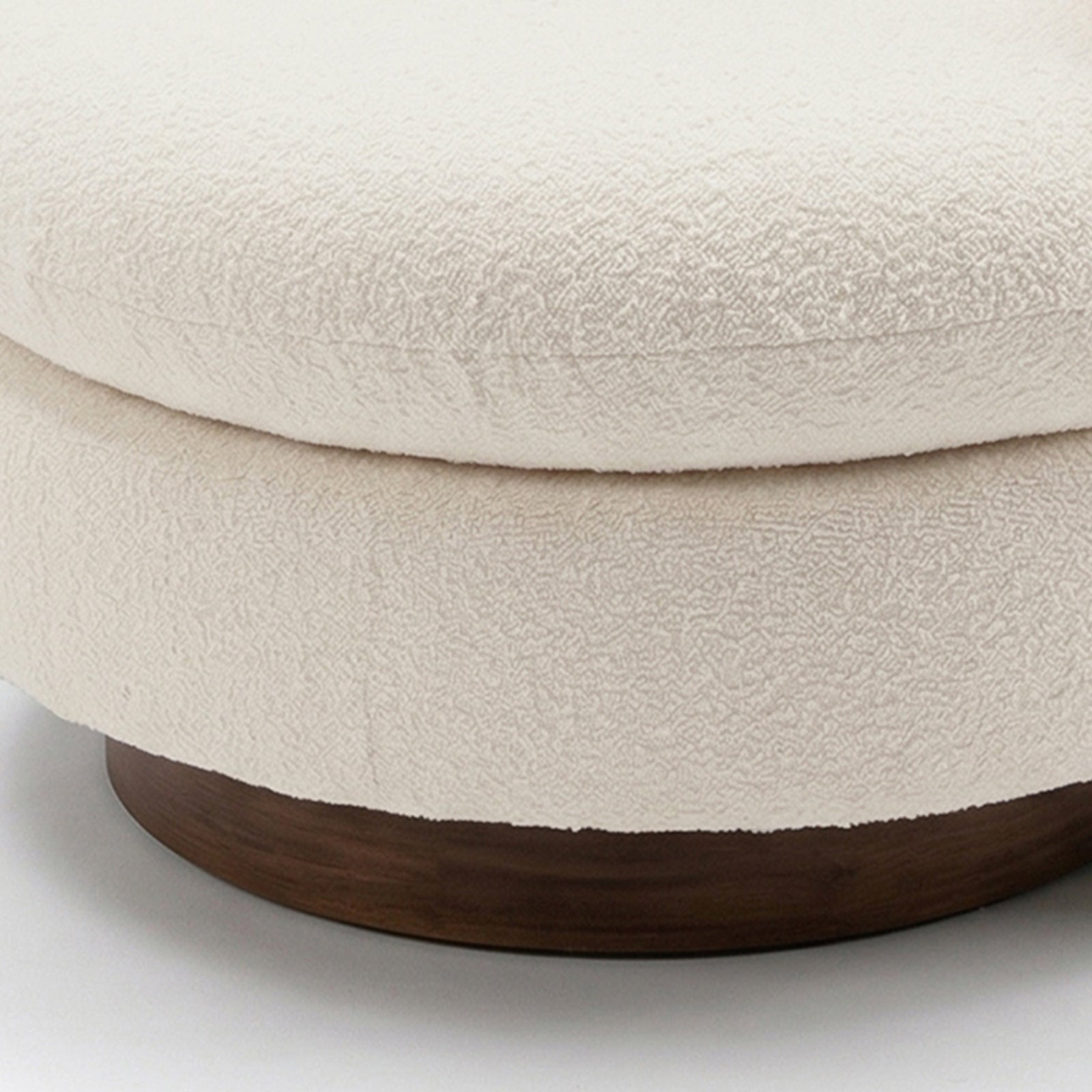 Close-up of the Marvik 360° Swivel Accent Chair in Cream White, showcasing its textured boucle upholstery on a round cushion, atop a dark wood base, emphasizing its modern, elegant design.