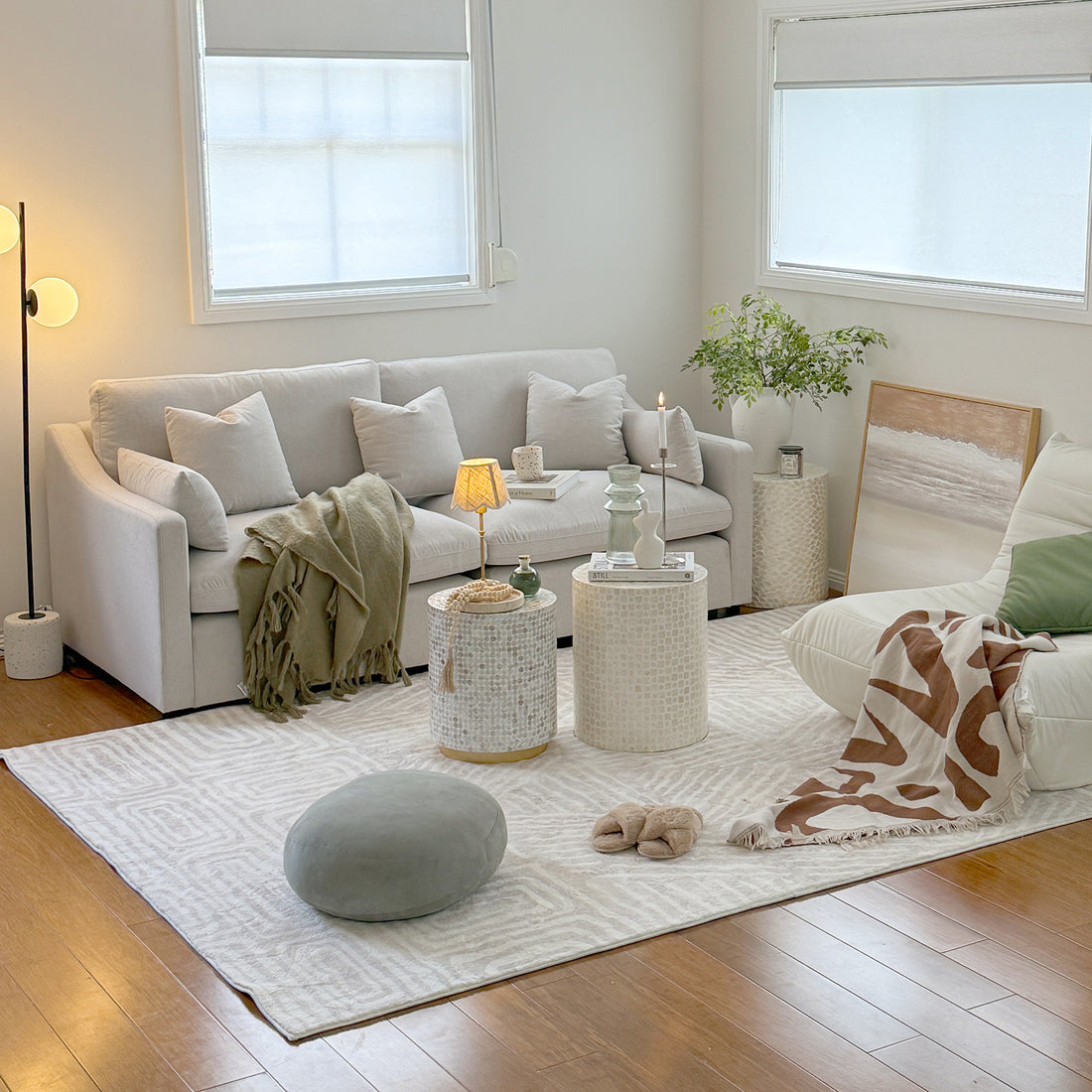 Millie 3-Seater Fabric Modular Sofa - Warm Light Grey, displayed in a modern living room setting with a grey round pillow, showcasing its spacious seating and soft linen fabric.