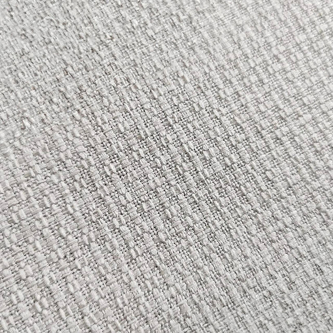 Millie 4-Seater Fabric Corner Chaise Sofa - Light Grey, featuring a close-up of its textured woven linen surface, showcasing the plush, cloud-like comfort of its high-density foam cushions.
