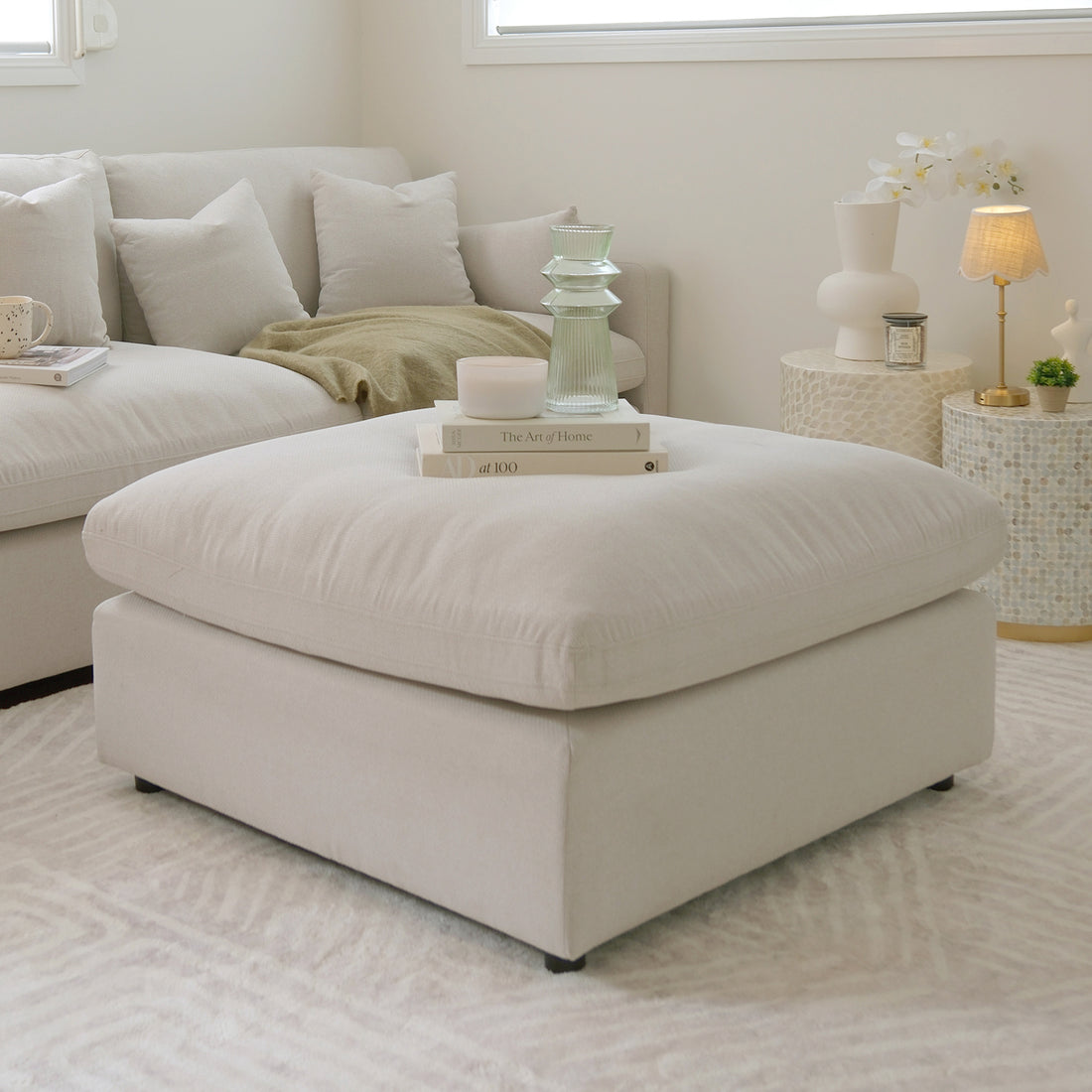 Millie Fabric Ottoman Modular Sofa Light Beige on a couch, showcasing its plush texture and modular design, ideal for enhancing living room comfort and style.