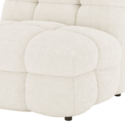 Close-up of Norah 5 Seater Bouclé Sofa Set with Ottoman in Cream White showing chunky tufted cushions, cream-white bouclé fabric, and a low, dark wooden leg.