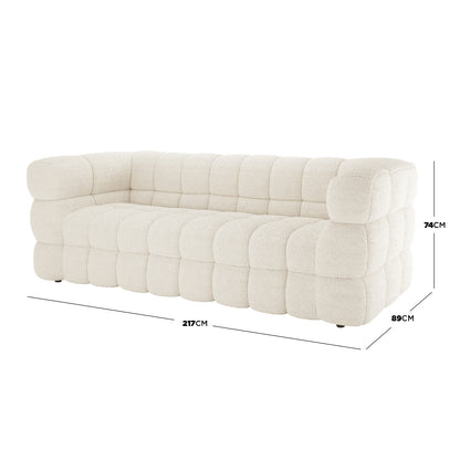 Norah 5 Seater Boucle Sofa Set with Ottoman in Cream White features a modern, low-profile design with tufted, cloud-like cushions. Dimensions: 217 cm wide, 89 cm deep, 74 cm tall.