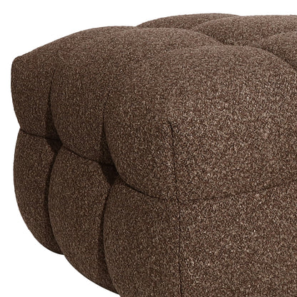 Norah Boucle Ottoman in Brown: Close-up of a plush, tufted ottoman upholstered in boucle fabric, showcasing its rounded button-down sections, ideal for stylish seating or a footrest.