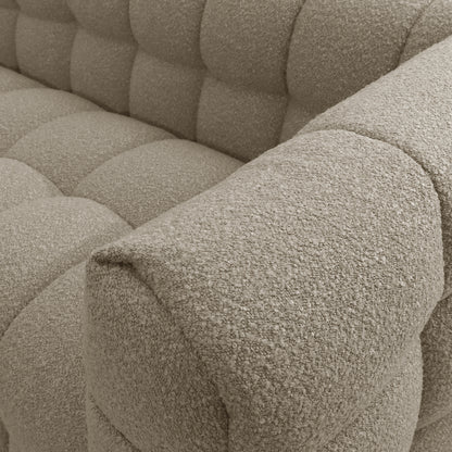 Norah 5 Seater Boucle Sofa Set With Ottoman in Warm Beige, showcasing tufted, nubby boucle upholstery with oversized quilted squares on the seat, back, and arms, exuding elegance and comfort.