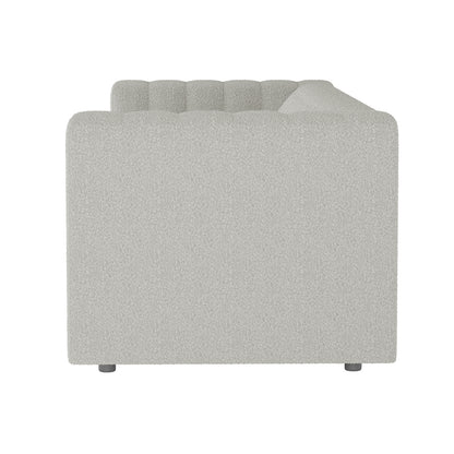 Side view of the Parisa 3 Seater Tufted Boucle Sofa in Light Grey, showcasing its textured fabric, low squared arm and back with channel tufting, and small cylindrical metal legs.