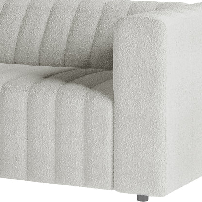 Close-up of Parisa 3 Seater Tufted Boucle Sofa showcasing its plush boucle fabric and elegant tufted detailing, highlighting the modern design and inviting texture.