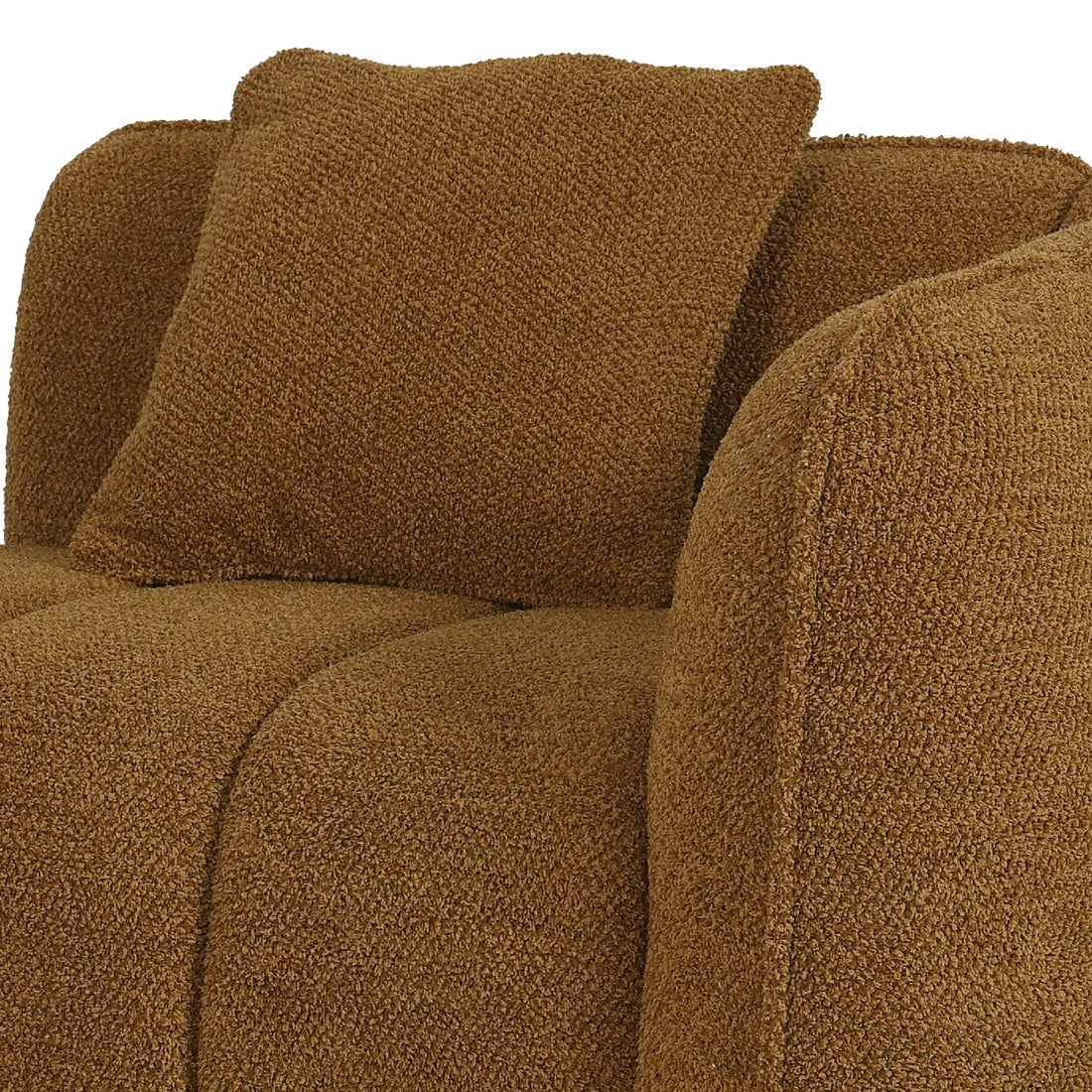 Close-up of a modern armchair upholstered in a textured, mocha brown bouclé fabric with a matching square throw pillow.