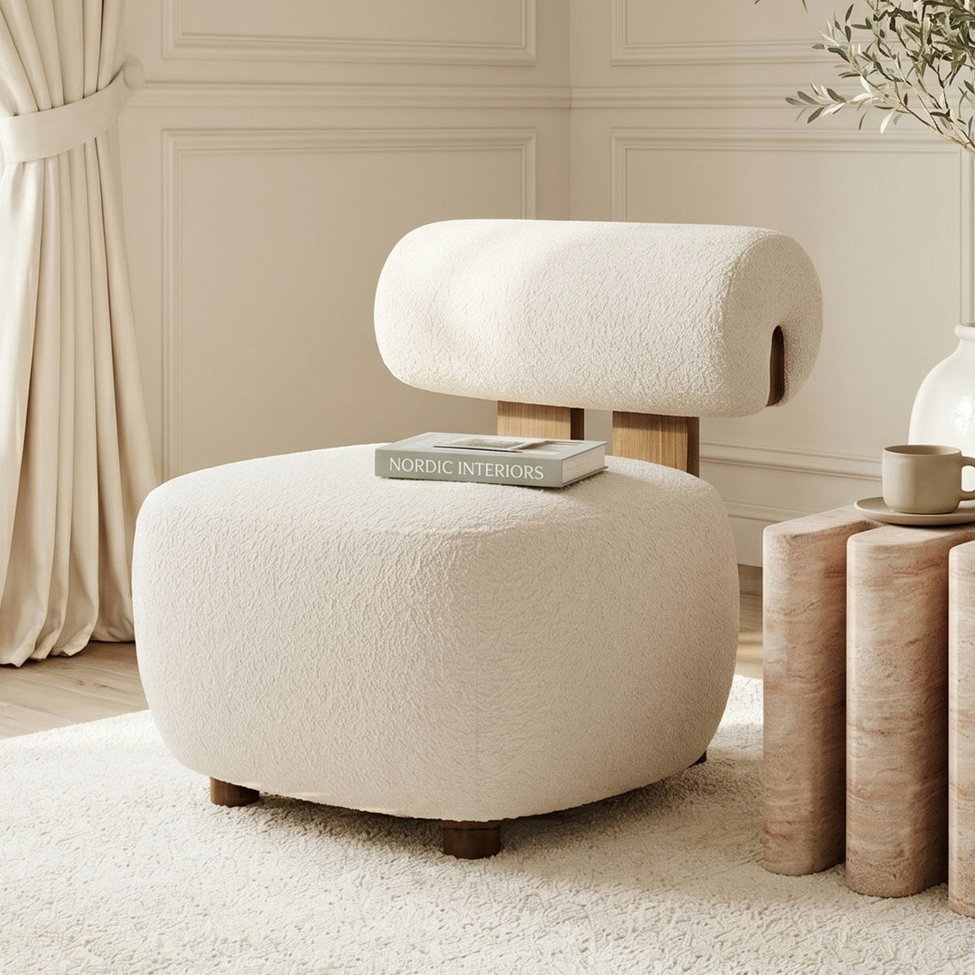 Renley Boucle Armless Accent Chair in Cream White, featuring plush boucle texture and modern organic lines, accompanied by a matching ottoman on a cream rug with a side table and decor accents.
