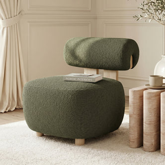 Renley Boucle Armless Accent Chair in Dark Forest Green, featuring plush boucle upholstery, light wood legs, and a cylindrical backrest, set in a minimalist Scandinavian-inspired living space.