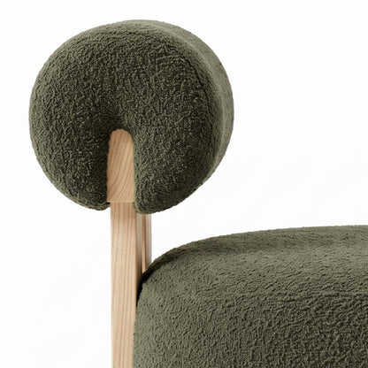 Renley Boucle Armless Accent Chair in Dark Forest Green, showcasing light wood frame, textured olive-green bouclé upholstery, with plush seat cushion and rounded backrest, embodying minimalistic elegance and modern comfort.