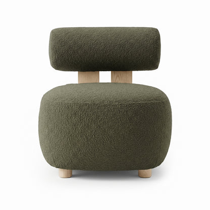 Renley Boucle Armless Accent Chair in Dark Forest Green with rounded pouf design, textured bouclé fabric, cylindrical wooden legs, and a matching floating headrest cushion on wood supports.