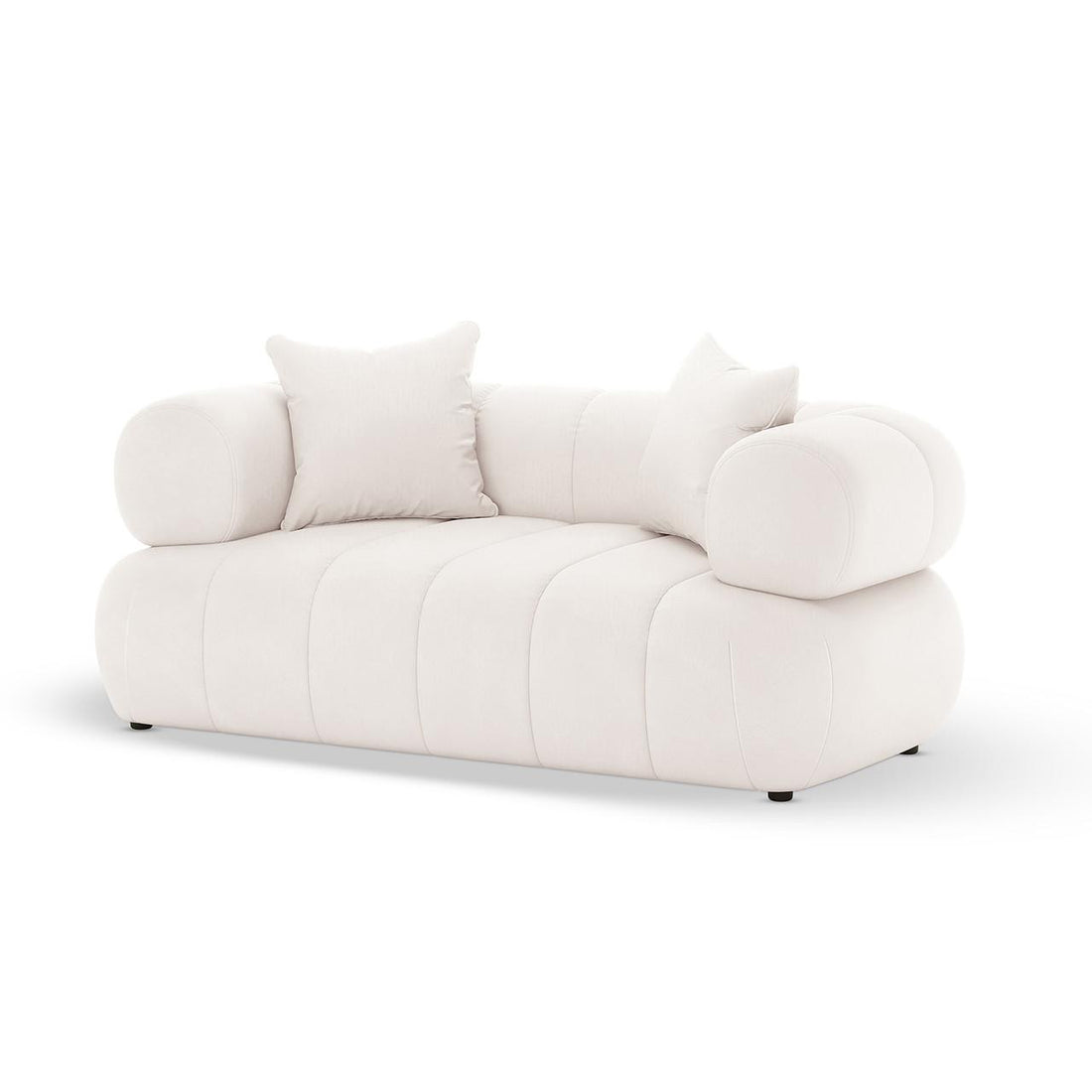 Samira 5 Seater Velvet Sofa Set in Cream features a modern, low-profile design with channel-tufted base, cylindrical bolster arms, and matching throw pillows, offering an elegant and plush seating experience.