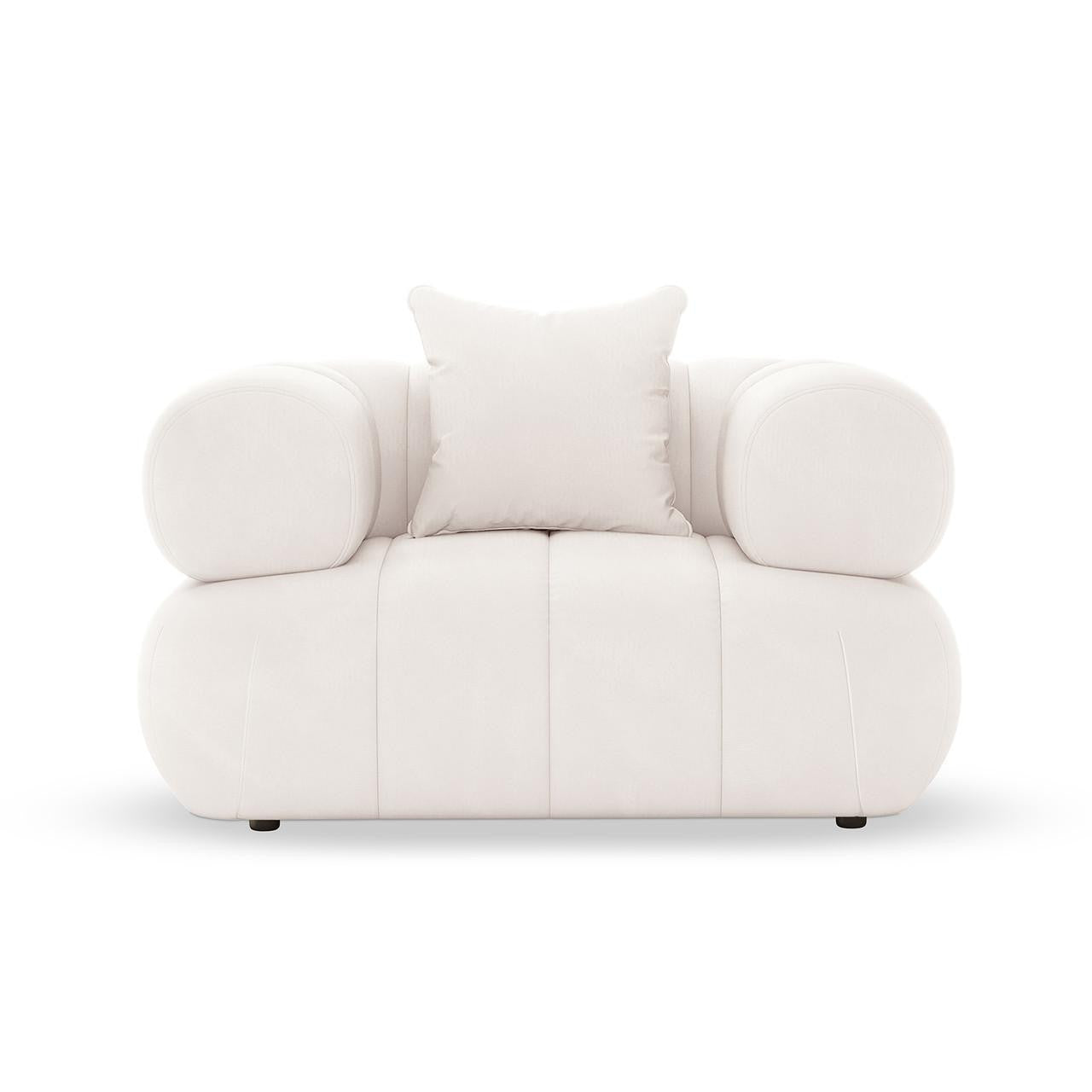 Samira Single Seater Velvet Sofa Cream, featuring plush velvet upholstery and a single pillow, elegantly perched on a couch with sturdy armrests, showcasing luxurious comfort and sophistication in design.