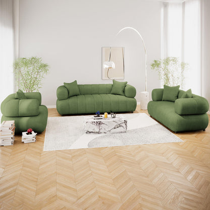 Samira 6 Seater Velvet Sofa Set Prasinous Green displayed in a stylish interior with a green couch, accented by plush pillows and a sleek lamp, exemplifying modern elegance and comfort.