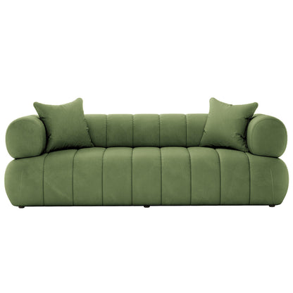 Samira 6 Seater Velvet Sofa Set Prasinous Green displayed with plush pillows on a green couch, showcasing luxurious velvet texture and elegant design.