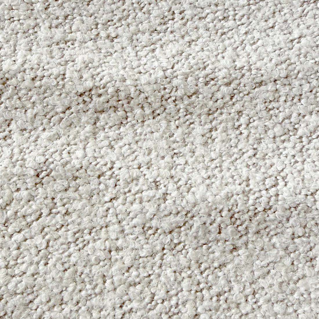 Close-up of the Sornel Boucle Upholstered Accent Chair in Cream White, highlighting its textured loop-pile fabric, emphasizing plushness and inviting design, embodying modern elegance and structural durability.