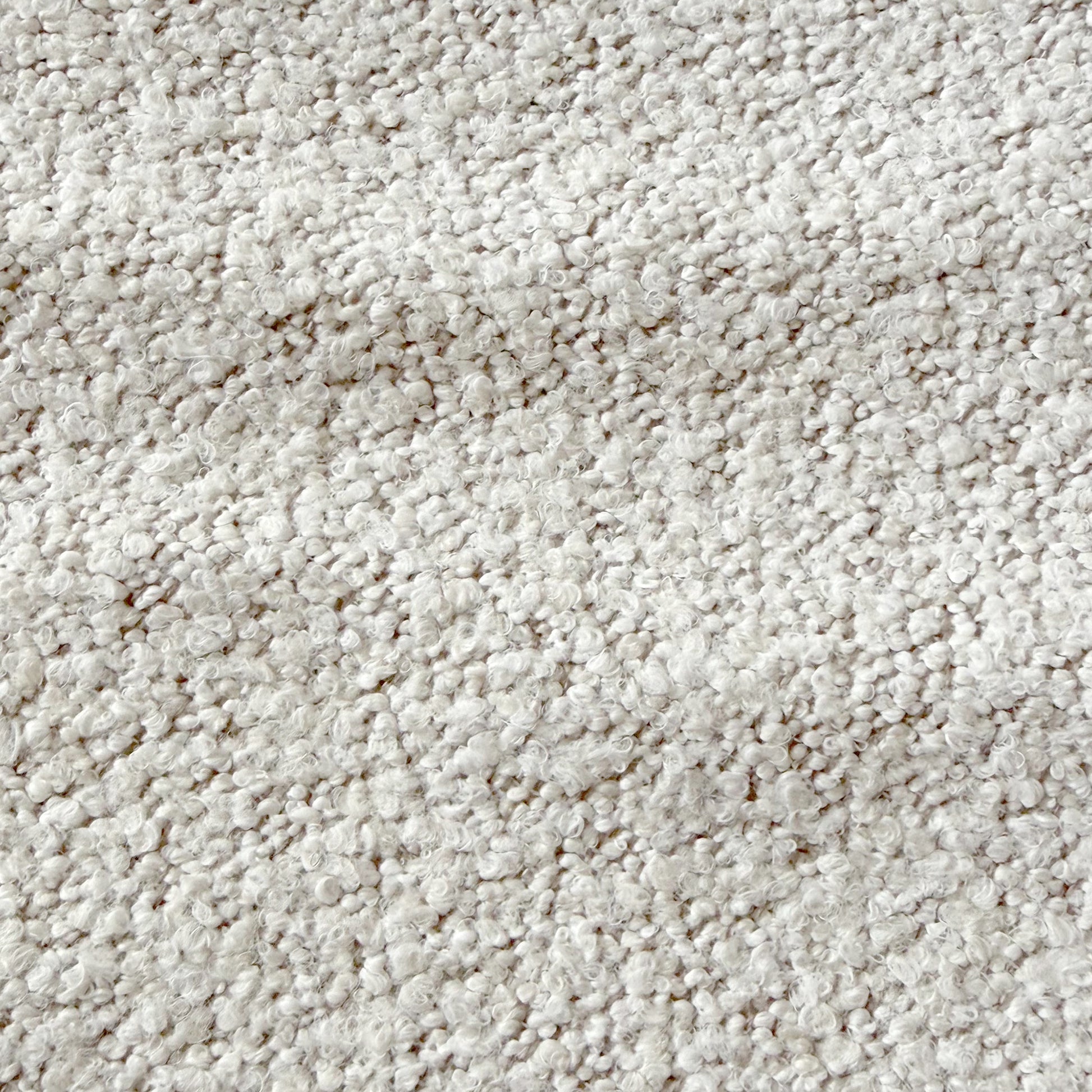 Close-up of the Sornel Boucle Upholstered Accent Chair in Cream White, highlighting its textured loop-pile fabric, emphasizing plushness and inviting design, embodying modern elegance and structural durability.