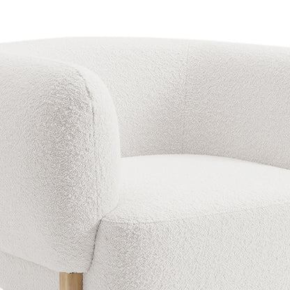 Close-up of the Sornel Boucle Upholstered Accent Chair in Cream White, highlighting its rounded arm and back cushions with textured boucle fabric and a glimpse of the wooden leg beneath.