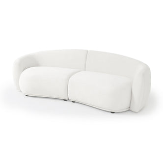 Modern curved white upholstered sofa on white background