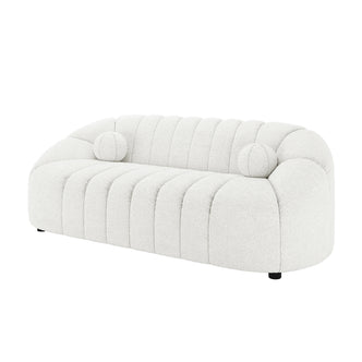 Trina 3 Seater Boucle Sofa with Pillows in Cream White features a curved, channel-stitched design with plush bouclé fabric and two round bolster pillows, offering contemporary elegance and comfort.
