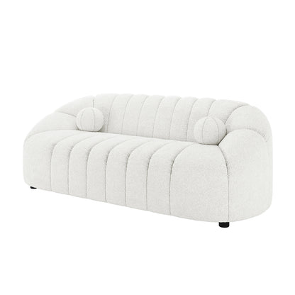 Trina 3 Seater Boucle Sofa with Pillows in Cream White features a curved, channel-stitched design with plush bouclé fabric and two round bolster pillows, offering contemporary elegance and comfort.
