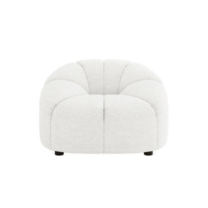 Trina 6 Seater Boucle Sofa Set features a low-sitting, single-seat lounge chair module in white boucle fabric, with rounded, petal-like cushion sections and discreet black feet, enhancing chic comfort.