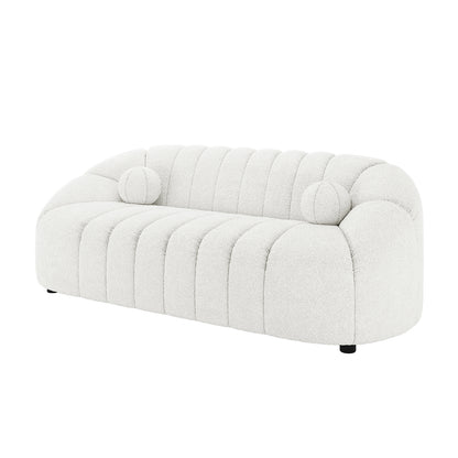 Trina 6 Seater Boucle Sofa Set with Pillows in Cream White features a modern, low-profile design with curved back and arms, channel-stitched tufting, and cylindrical bolster pillows, exuding chic elegance.