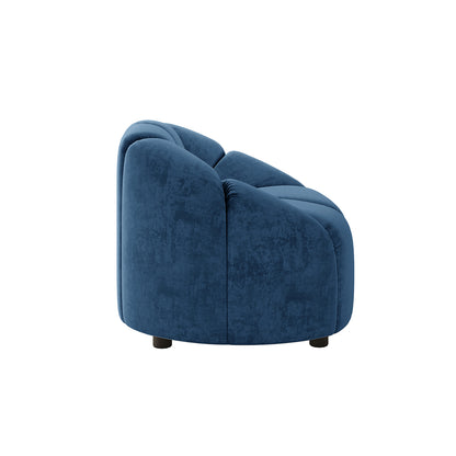 Trina Single Velvet Tufted Accent Chair in Blue, featuring a rounded silhouette, rich velvet upholstery, channel-style tufting, and short dark legs, exemplifies elegance and modern comfort.