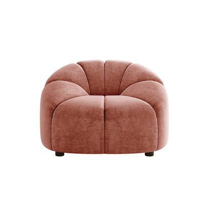 Trina Velvet Sofa Chair with Ball Pillow in Blush features a plush, petal-like design with soft velvet upholstery, accentuated by a matching ball pillow. Its low profile and modern elegance enhance any decor.