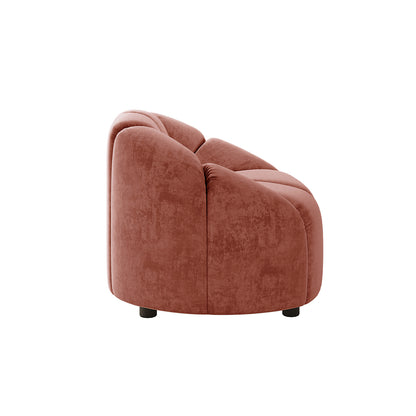 Trina Velvet Sofa Chair with Ball Pillow in Blush features a plush, rounded design with velvety tufts, short wooden legs, and a whimsical ball pillow, perfect for modern living spaces.