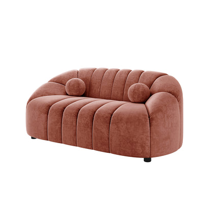 Trina 2 Seater Tufted Curved Velvet Sofa in Blush, showcasing a fluted channel-stitched design, rounded armrests, and two cylindrical bolster pillows, offering a modern, compact elegance with plush comfort.