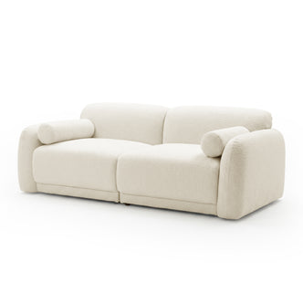 Cream-colored two-seater sofa on white background