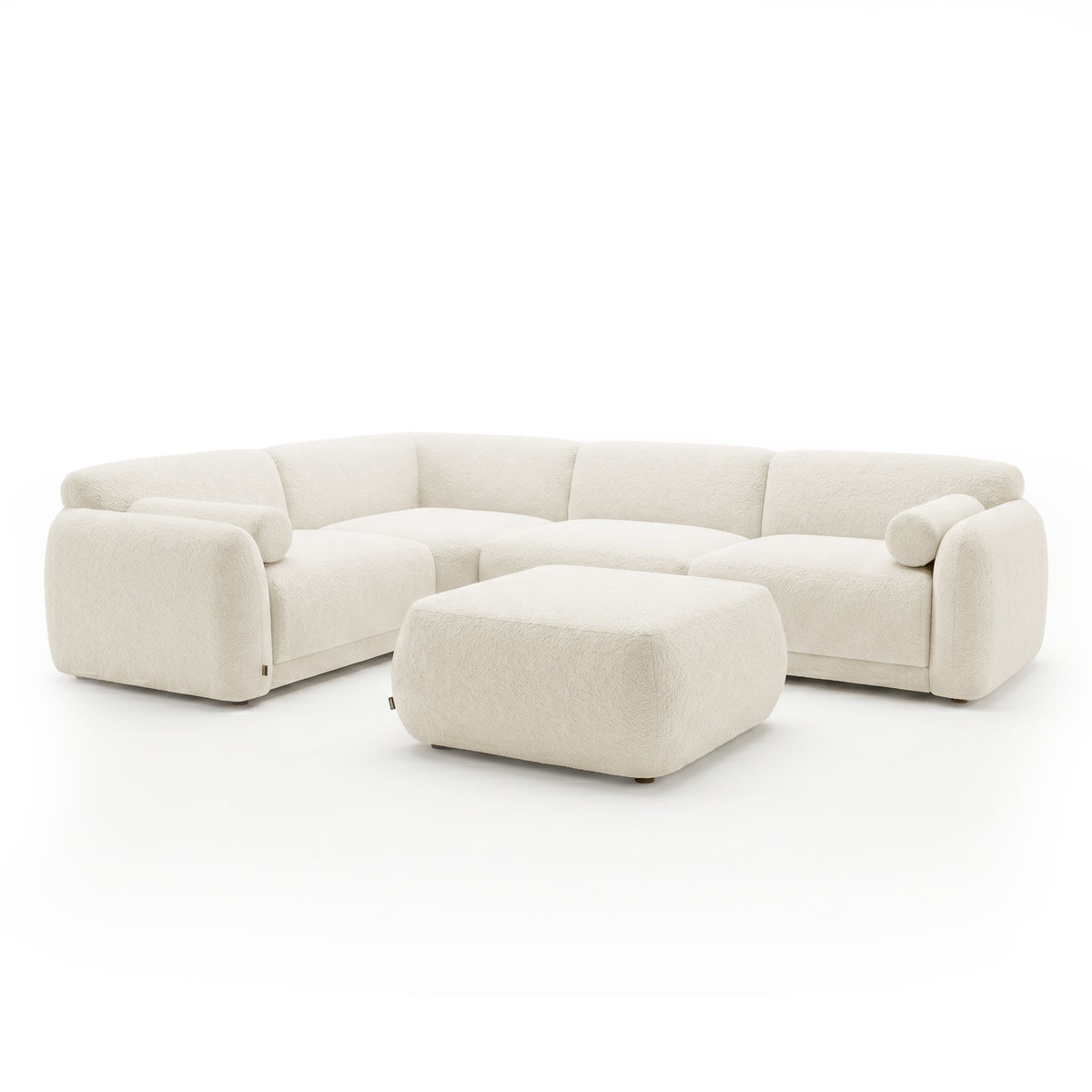 Cream sectional sofa with matching ottoman on a white background