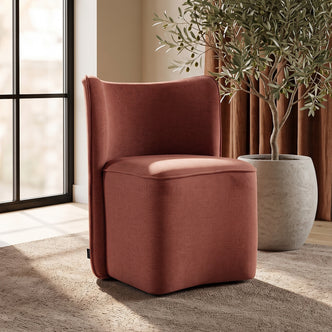 Rust-colored upholstered chair in a warm room setting