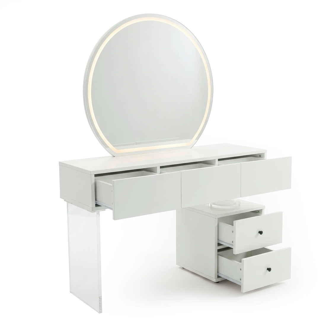 A modern white dressing table featuring a large, round, illuminated mirror, a wide table with three shallow drawers, and a side cabinet with two additional drawers, all supported by a transparent acrylic leg.