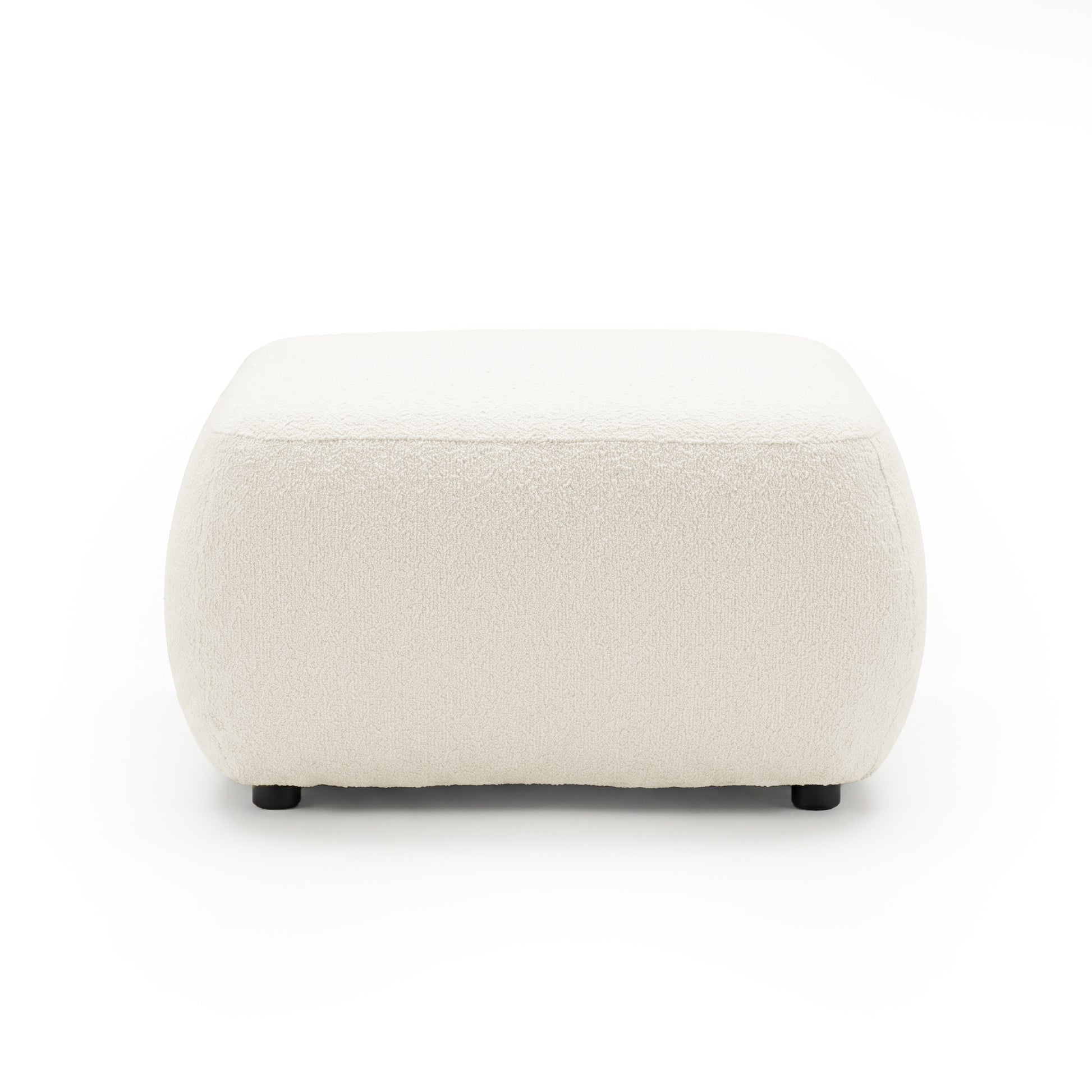 Cream upholstered ottoman on white background