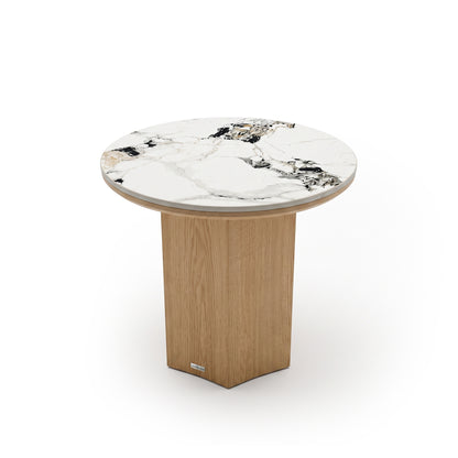 Modern round table with marble-look top and light wood pedestal base on a white background