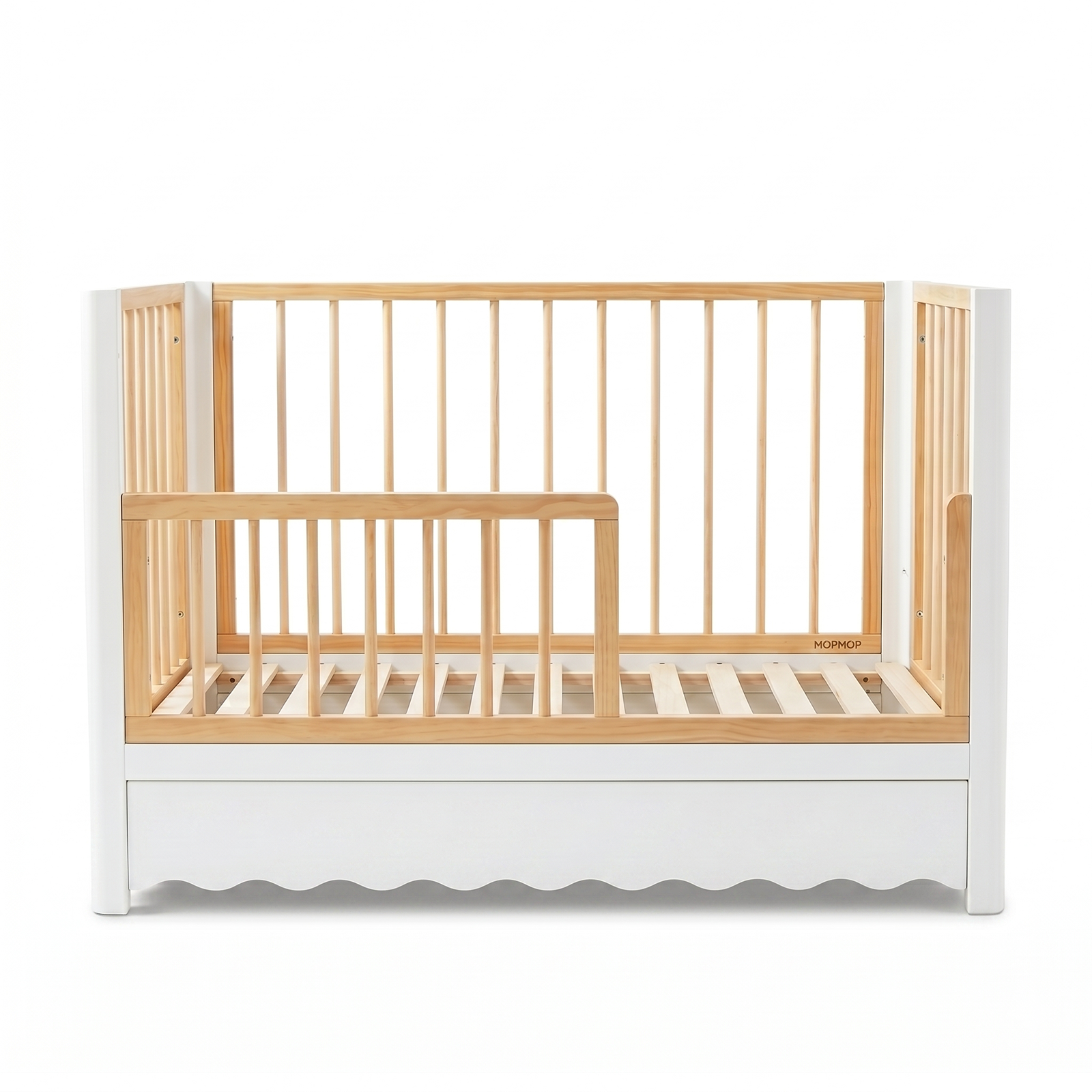Modern white and natural wood baby crib with scalloped base on white background