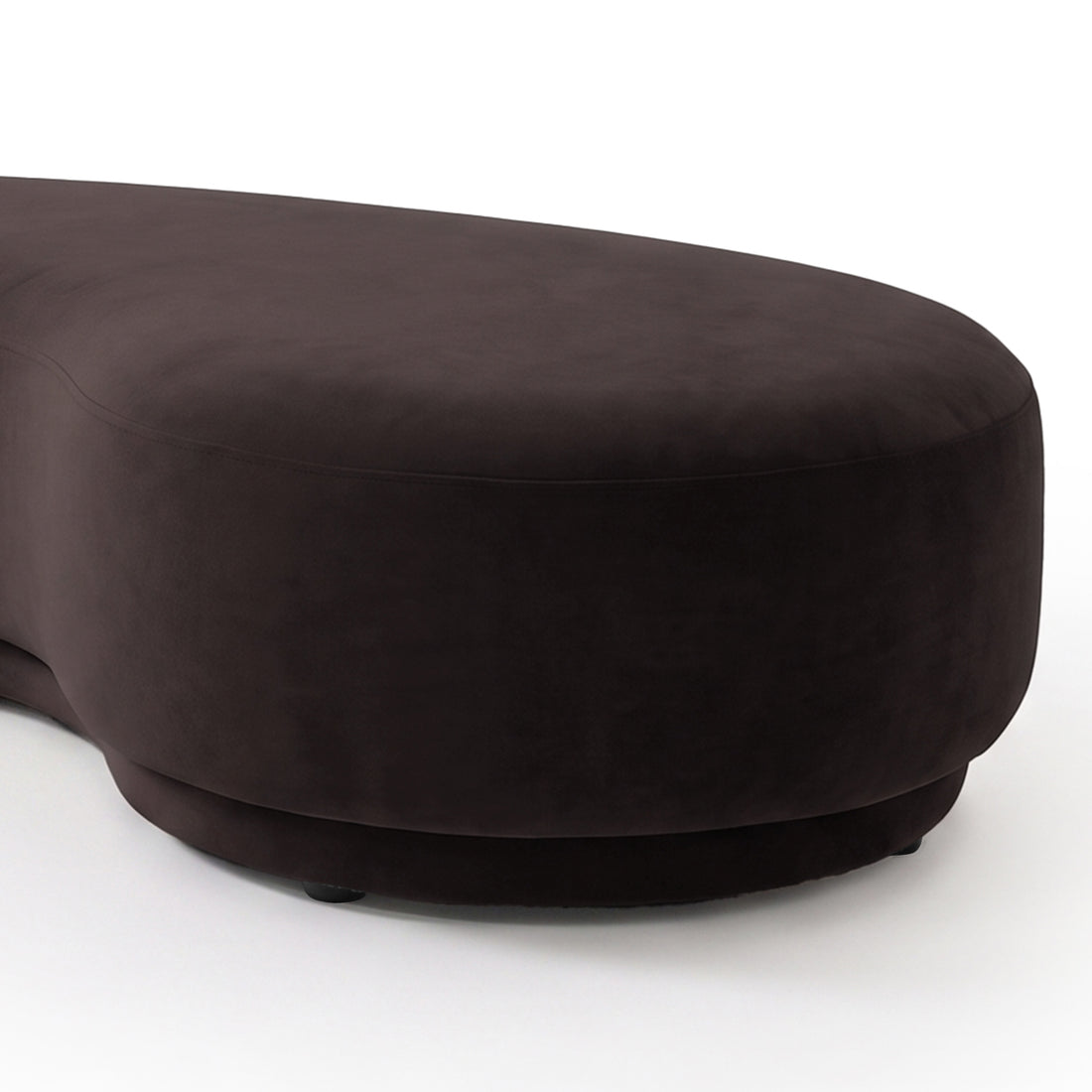 Close-up partial view of a plum curved upholstered product on a light background